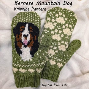 May include: A pair of green and white knitted mittens. One mitten features a Bernese Mountain Dog design, while the other has a white pattern on the back. The text "Bernese Mountain Dog Knitting Pattern" and "Digital PDF File" are visible.