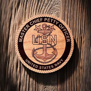 May include: A wooden plaque with a rope border, featuring the United States Navy emblem. The emblem is a gold anchor with a chain, surrounded by the words "Master Chief Petty Officer" and "United States Navy".
