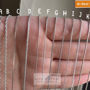 May include: A close-up of 12 different silver chain styles labeled A through L. The chains are held in a hand, with the text "#1 Best Seller" in the top right corner.