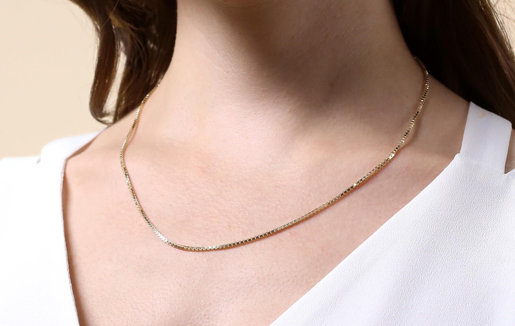 Jh stamp shop on gold necklace