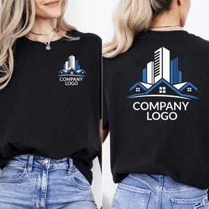 May include: Black t-shirt with a company logo design. The logo features a stylized building design in white and blue, with the words "COMPANY LOGO" below. The design is on the front and back of the shirt.