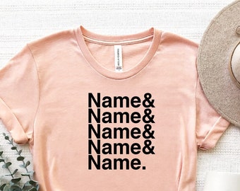 May include: A light pink t-shirt with the text "Name & Name & Name & Name & Name." printed in black.