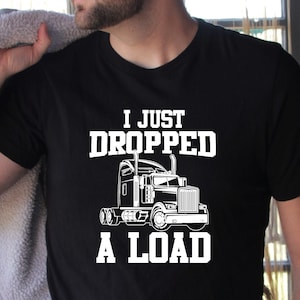 May include: A black t-shirt with a white graphic of a semi-truck and the text "I just dropped a load".