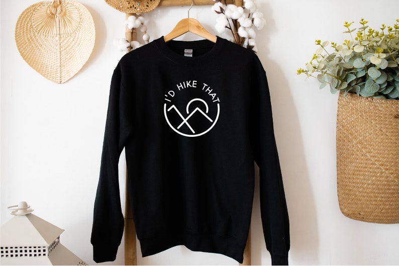 May include: Black sweatshirt with a white graphic that says "I'd Hike That" with a mountain and sun design.