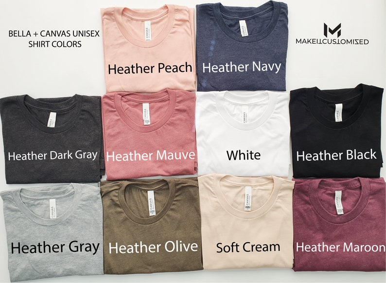 May include: A collection of Bella + Canvas unisex t-shirts in various colors, including heather peach, heather navy, heather dark gray, heather mauve, white, heather black, heather gray, heather olive, soft cream, and heather maroon. The shirts are laid out in rows of two, with the color names printed below each shirt.