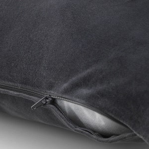 May include: A dark gray pillow with a zipper closure. The zipper is open, revealing the gray fabric lining.