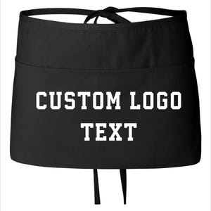 May include: Black waist apron with white text reading "CUSTOM LOGO TEXT". The apron features a tie closure and a pocket. Suitable for businesses and events, this apron is a practical item.
