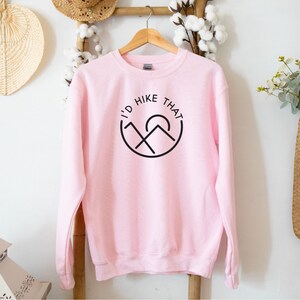 May include: A pink sweatshirt with a black graphic that says "I'd Hike That" with a mountain and sun design.