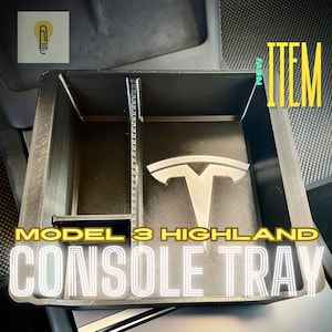 May include: Black plastic Model 3 Highland Console Tray with a Tesla logo and dividers. "NEW ITEM" is written in white text on a black background.