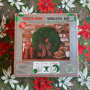 May include: A Quick-Mac wreath kit with a green wreath on the cover. The kit includes instructions for cutting, tying, and brushing. The box is on a green and red floral patterned background. The text on the box says "Made in America."