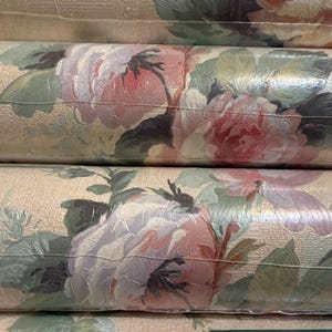 May include: A white ceramic mug with a black handle and the text "But First, Coffee" in a black, bold font. The mug is on a white surface.