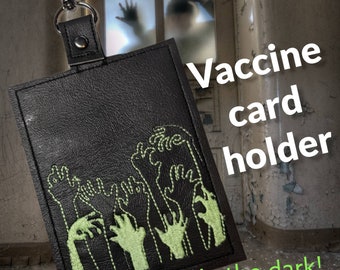 Braaiins glow in the dark vaccination card protector. Space for valuebles. Attach to purse, bag, backback or beltloops Vinyl, cork, leather.