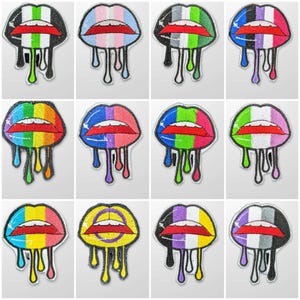 May include: Twelve embroidered iron-on patches featuring different pride flags in the shape of dripping lips. The flags include the rainbow, transgender, bisexual, lesbian, asexual, genderqueer, intersex, pansexual, non-binary, and agender flags.