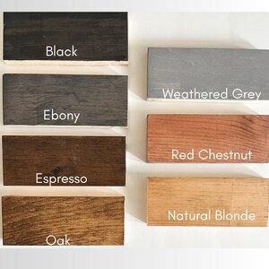 May include: Five wood samples stained in different colours: black, ebony, espresso, red chestnut, and natural blonde. The wood samples are arranged in two rows, with the top row showing black, ebony, and red chestnut, and the bottom row showing espresso, oak, and natural blonde.