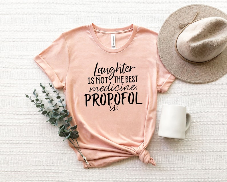 May include: A pink t-shirt with the text "Laughter is not the best medicine. Propofol is." printed in black.