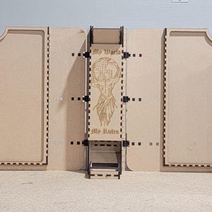 May include: A modular, wooden gaming terrain set. The set is made of light brown wood and features hinged panels with decorative cutouts and a central structure with a detailed design. The panels are connected with black hinges.
