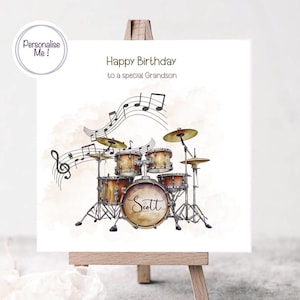 May include: A personalised birthday card featuring a watercolour illustration of a drum kit with musical notes. The card says "Happy Birthday to a special Grandson" and the name "Scott" is written on the bass drum.