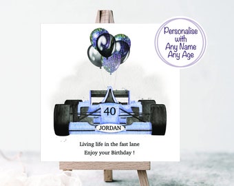 May include: A blue race car with black tires and a number 40 on the side. The car is decorated with blue and black balloons. The text "JORDAN" is printed on the car. The text "Living life in the fast lane Enjoy your Birthday!" is printed below the car. The text "Personalise with Any Name Any Age" is printed in a circle in the upper right corner.