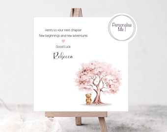 May include: A pink watercolor tree with a brown teddy bear standing beneath it. The text "Here's to your next chapter New beginnings and new adventures Good Luck Rebecca" is printed on the card.