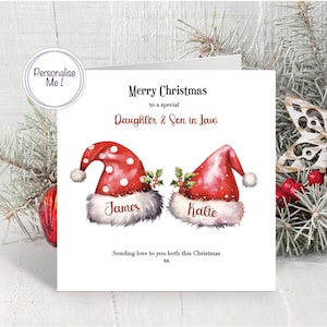 May include: A square Christmas greeting card featuring two red Santa hats with white polka dots and fluffy white trim. The text reads Merry Christmas to a special Daughter & Son in Law, James, Katte, and Sending love to you both this Christmas xx.