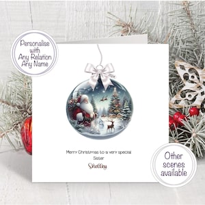 May include: A square Christmas greeting card featuring a central illustration of a glass ornament containing a winter scene with Santa Claus, a reindeer, and a decorated tree. The text reads Merry Christmas to a very special Sister Shelley.
