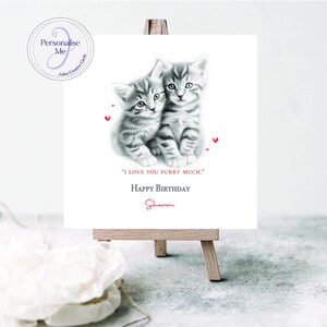 May include: A personalized birthday card featuring a black and white illustration of two kittens with red hearts. The card reads "I love you furry much." Happy Birthday Sharon.