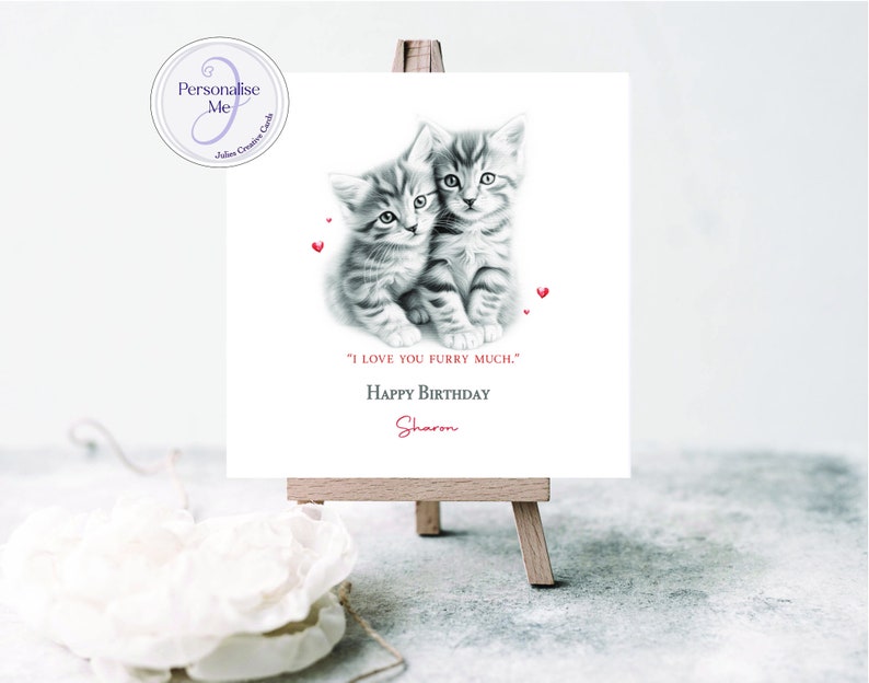 May include: A personalized birthday card featuring a black and white illustration of two kittens with red hearts. The card reads "I love you furry much." Happy Birthday Sharon.