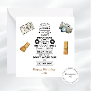 May include: A square greeting card featuring two watercolour cameras and film strips. The text reads: Life is like a camera, focus on what's important, capture the good times, develop from the negatives, and if things don't work out, take another shot.