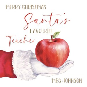 May include: A Christmas-themed illustration featuring a red apple held in a white-gloved hand, with the text "Merry Christmas Santa's Favourite Teacher" in red and gold script. The name "MRS JOHNSON" is at the bottom.