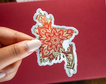 May include: A die-cut sticker shaped like the map of Bangladesh, featuring a pale green background overlaid with intricate, symmetrical red mandala patterns that follow the contours of the country's geographical borders and coastline.