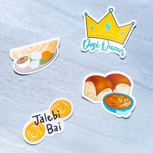 May include: Four colourful stickers featuring Indian food. The first sticker shows a yellow crown with the text "Desi Queen". The second sticker shows a plate of food with a dosa, idli, and sambar. The third sticker shows two jalebis with the text "Jalebi Bai". The fourth sticker shows a bowl of dal with two pieces of bread.