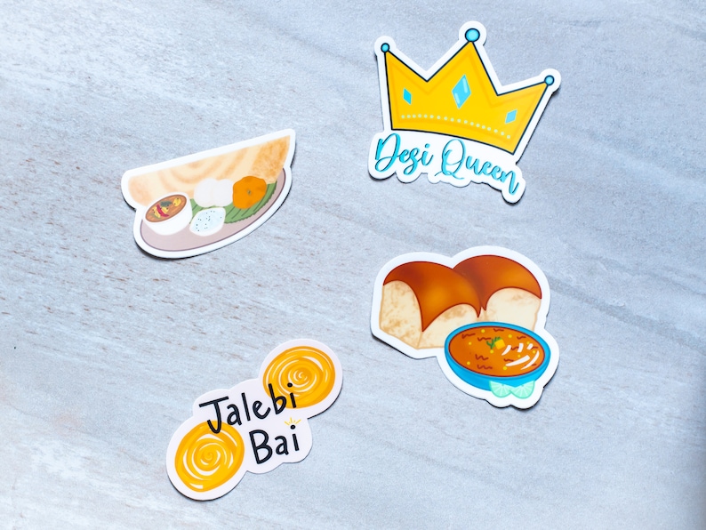May include: Four colourful stickers featuring Indian food. The first sticker shows a yellow crown with the text "Desi Queen". The second sticker shows a plate of food with a dosa, idli, and sambar. The third sticker shows two jalebis with the text "Jalebi Bai". The fourth sticker shows a bowl of dal with two pieces of bread.