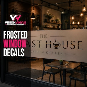 May include: A frosted window decal applied to a glass storefront, featuring the text THE ROAST HOUSE COFFEE & KITCHEN with a coffee cup graphic. The semi-transparent film obscures the view into the interior cafe setting with tables and chairs.