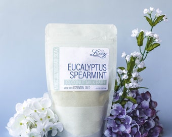 May include: A white pouch with a label that reads "LUXINY Eucalyptus Spearmint Coconut Milk Bath Made with Essential Oils +8.0 oz/225g/8.0m"