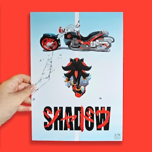May include: A black and red motorcycle with a black and red hedgehog character standing in front of it. The background is light blue with a white line down the middle. The text "SHADOW" is written in red and black letters at the bottom of the image.