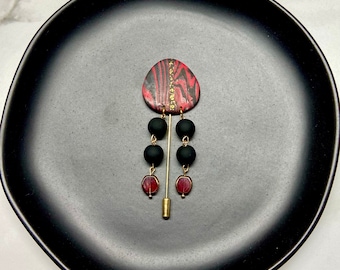 Modern stickpin in black, red, and gold