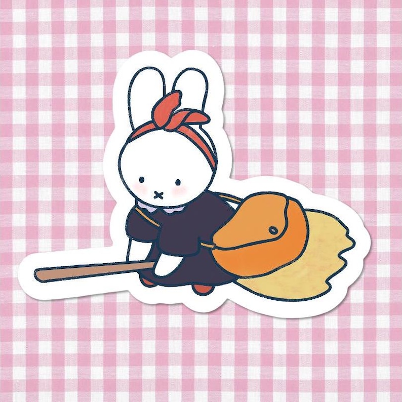 May include: A sticker of a white cartoon rabbit wearing a red headband and a dark purple dress. The rabbit is holding a broom and an orange bag, on a pink and white gingham background.