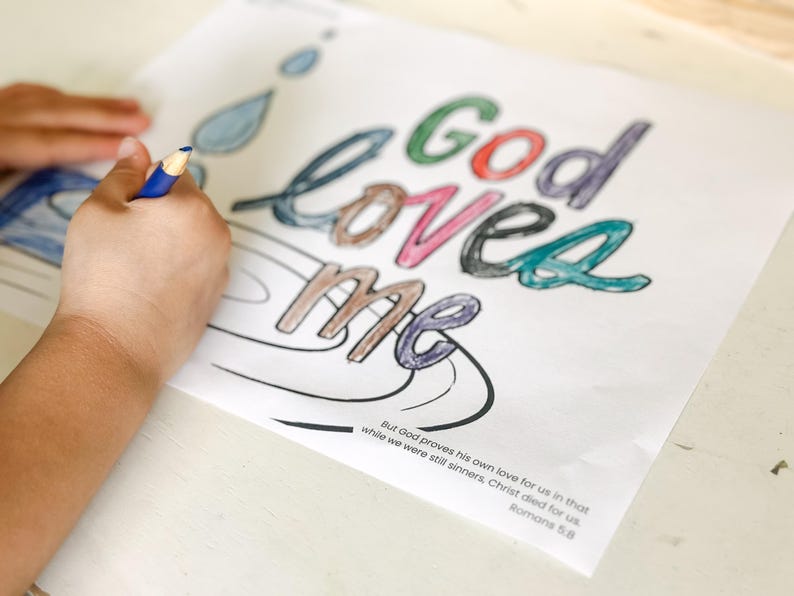 May include: A coloring page with the words "God loved me" in colorful letters. The page includes a quote from Romans 5:8, "But God proves his own love for us in that while we were still sinners, Christ died for us."