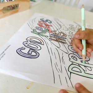 May include: A coloring page with the words "God Keeps His Promises" written in a colorful, stylized font. The page is partially colored in with green, blue, and red crayons. The text "Day 8: Jesus Taught About Worry Matthew 6:25-34" is printed at the bottom of the page.