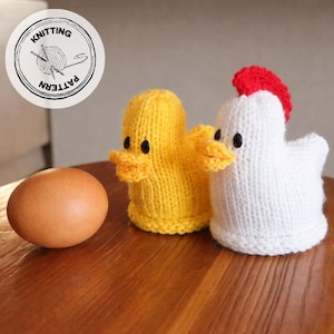 May include: A knitted yellow duck and white chicken with black button eyes and orange beaks. A brown egg sits next to the duck and chicken. The image includes a circular logo with the words "Knitting Pattern".