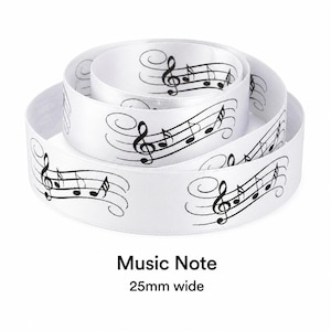 May include: A white satin ribbon coiled in a spiral, featuring a repeating black print of musical staves, treble clefs, and notes. The ribbon is labelled as Music Note and measures 25mm wide, providing a smooth texture and a clear, high-contrast design.