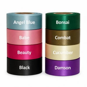 May include: Two stacks of satin ribbon rolls in various colors, including Angel Blue, Babe, Beauty, Black, Bonsai, Combat, Cucumber, and Damson. Each roll has a label with its color name in white text. The ribbons are arranged vertically.