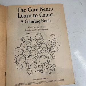 May include: A black and white colouring book featuring the Care Bears. The cover shows a group of Care Bears with their signature symbols. The title of the book is "The Care Bears Learn to Count: A Colouring Book".