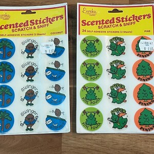 May include: Two packs of vintage scented stickers. One pack features coconut-themed stickers with palm trees and coconut characters. The other pack has pine-themed stickers with pine tree characters and the text "Pine Power" and "Pining".