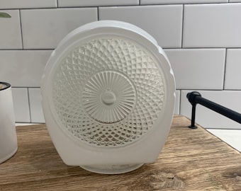 May include: White glass ceiling light fixture with a diamond pattern and a circular design.
