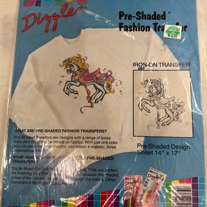 May include: Pre-shaded iron-on transfer design of a carousel horse with a pink and white saddle. The design is on a white t-shirt. The transfer sheet is 14 inches by 17 inches.