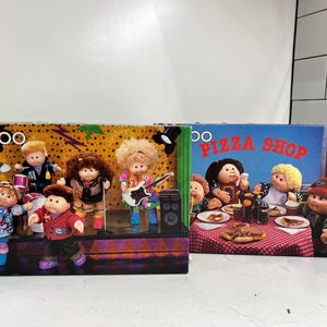 May include: A set of three ceramic nesting bowls in graduating sizes. The bowls feature a speckled, matte finish in shades of cream, light brown, and dark brown. The largest bowl is approximately 8 inches in diameter.