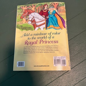 May include: A colouring book cover featuring a princess and prince riding horses through a forest. The cover is yellow with the title "Add a rainbow of colour to the world of a Royal Princess".