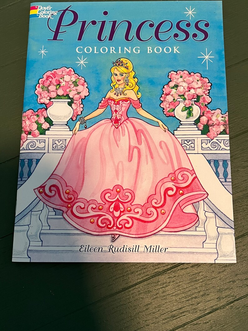 May include: A colouring book featuring a princess in a pink gown with a crown and jewellery. The book is titled "Princess Colouring Book" and has a blue background with stars. The book is by Eileen Rudisill Miller.