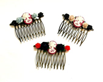 May include: Three antique gold hair combs with black, red, and white flowers and a cameo of a woman's profile.